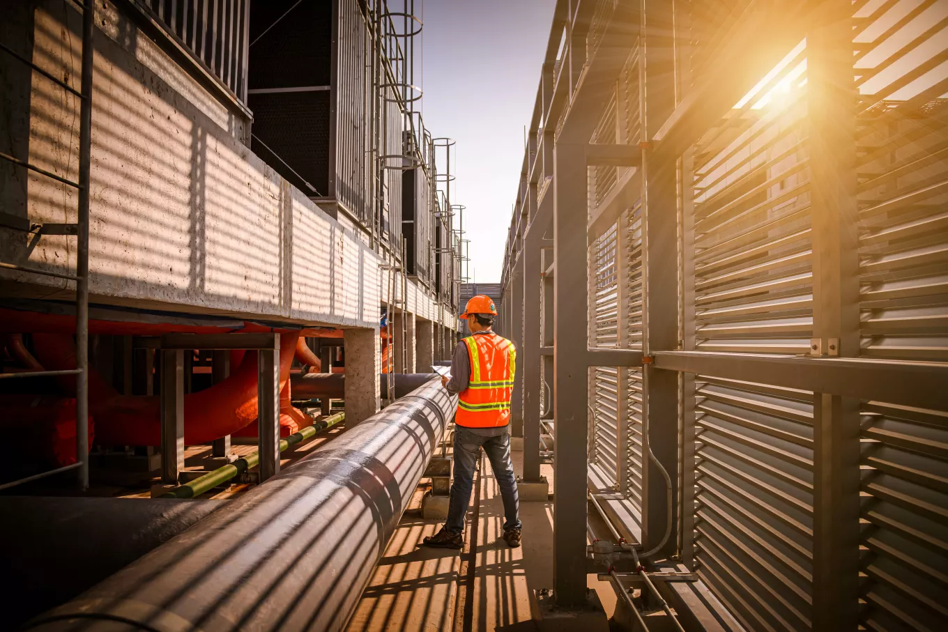 A engineer under checking the industry cooling tower air conditioner is water cooling tower air chiller HVAC of large industrial building to control air