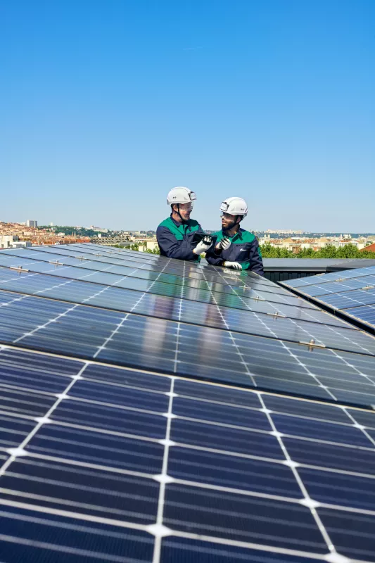 Two workers working on solar panel