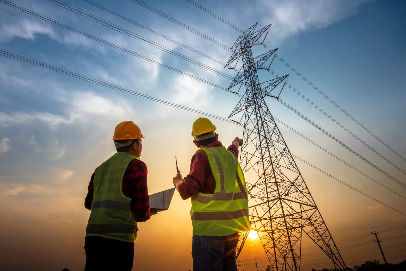 electrical engineer working at the power station See the planning of electricity production at high voltage poles