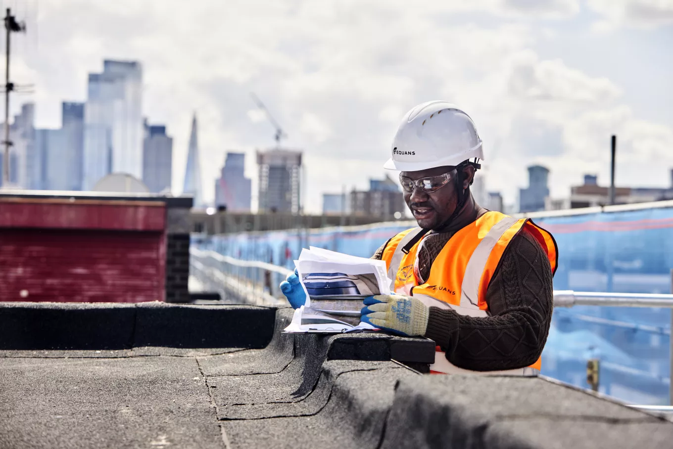 Equans engineer looking at some plans at Hackney energy efficiency construction