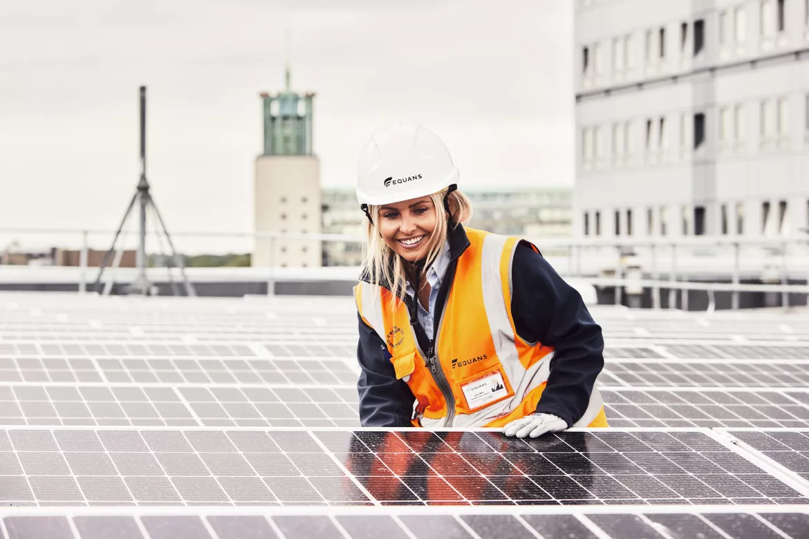 Woman engineer checking solar panels in the UK