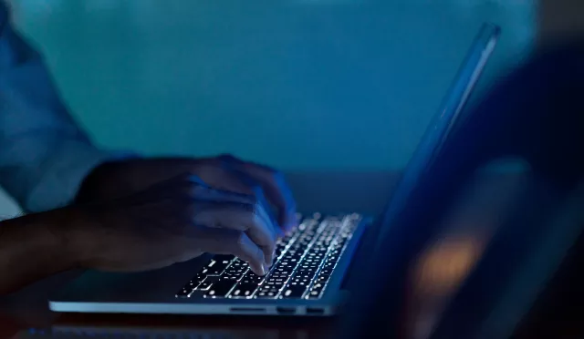 Close up businessman hand typing or working on laptop for programming about cyber security , advance future technology concept