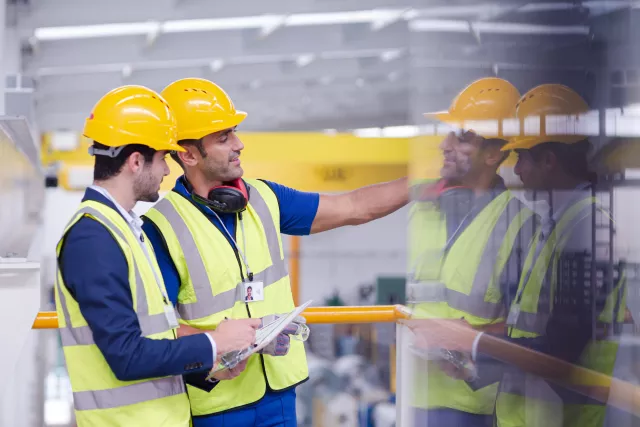one man explaining safety rules to his collegue