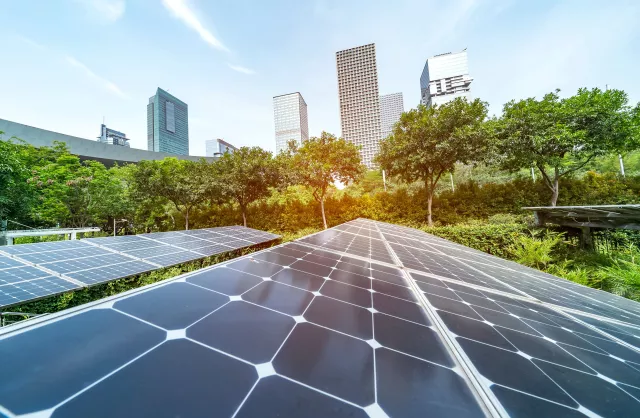 Ecological energy renewable solar panel plant with urban landscape landmarks